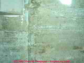 Photograph of cold pour joints and horizontal cracks in a poured concrete foundation wall