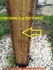 Checking cracks in a deck post (C) InspectApedia Hector