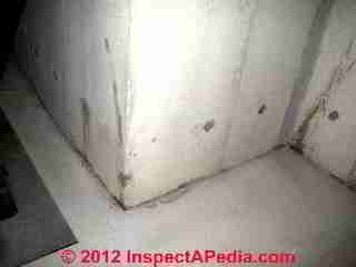 Photograph of contraditory diagonal "cracks" in a poured concrete foundation wall (C) InspectAPedia & C.C.