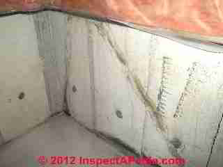 Photograph of contraditory diagonal "cracks" in a poured concrete foundation wall (C) InspectAPedia & C.C.