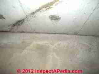 Photograph of contraditory diagonal "cracks" in a poured concrete foundation wall (C) InspectAPedia & C.C. 