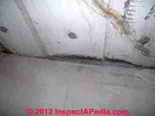 Photograph of contraditory diagonal "cracks" in a poured concrete foundation wall (C) InspectAPedia & C.C. 