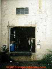 Photograph of impact damage to a foundation wall © Daniel Friedman at InspectApedia.com