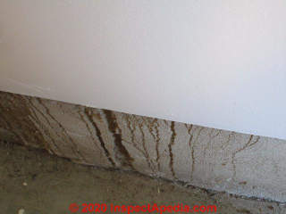 Gouged rivulet pattern damage to foundation parge coating (C) InspectApedia.com Alex