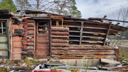 Collapsed wedge cut log cabin in Pines Michigan along Rte 28 shows interesting log cabin construction features (C) Daniel Friedman at InspectApedia.com