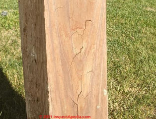 Horizontal and varied drying checking cracks in a wood post (C) InspectApedia.com peter