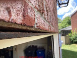 Sagging brick faschia over garage door (C) InspectApedia.com Dee