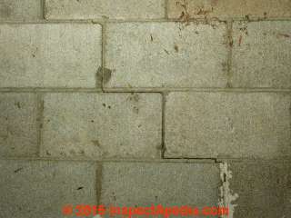 Step cracks in a concrete block wall need repair and remediation © Daniel Friedman at InspectApedia.com