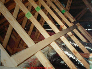 Strongback nailed at mid span on these roof trusses (C) Daniel Friedman at InspectApedia.com