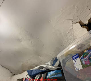 Badly water damaged ceiling sheet (C) InspectApedia.com Dim