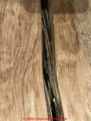 Splits in wood post, normal checking, up to nearly 1/2 the post diameter (C) InspectApedia.com Brittany