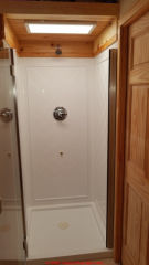 US 2022  NEC Electrical Code on lights and electrical fixtures over a tub or shower cited & discussed at InspectApedia.copm