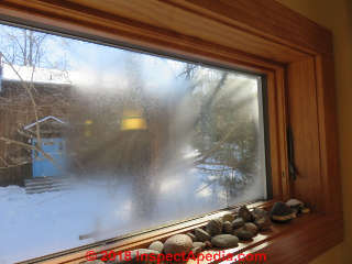 Condensation on window near soffit exahust for bathroom vent fan (C) Daniel Friedman at InspectApedia.com