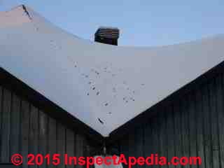 Snow on odd shaped roofs (Vassar Gym) or deep snow can make roof venting difficult; Venting towers are a common solution © D Friedman at InspectApedia.com 