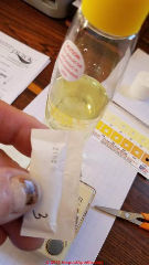 Adding zinc, reagent #3 to the arsenic test reaction bottle (C) Daniel Friedman at InspectApedia.com