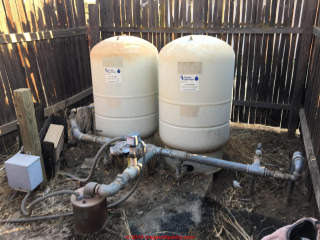 Dual water tanks located outdoors (C) InspectApedia.com DF