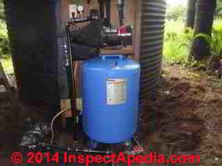 Outdoor water tank installation (C) InspectApedia.com