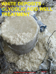 White material coming out of water well after well shocked with glycolic acid (C) InspectApedia.com Fields